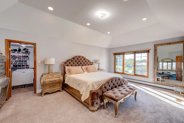 a bedroom with a bed and a large window