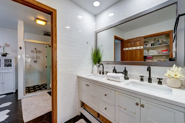 a bathroom with a sink double vanity and a mirror