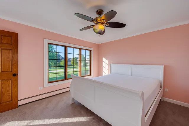 a bedroom with a large bed and a large window