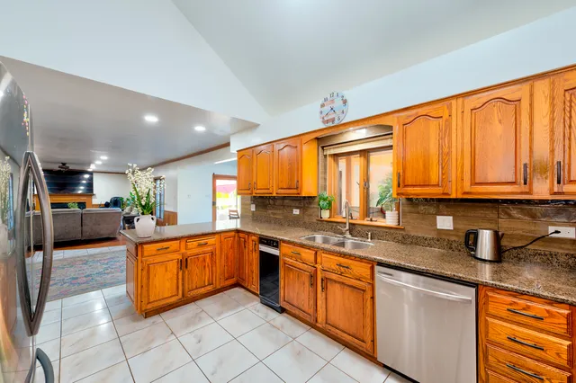 a kitchen with stainless steel appliances granite countertop a sink and cabinets