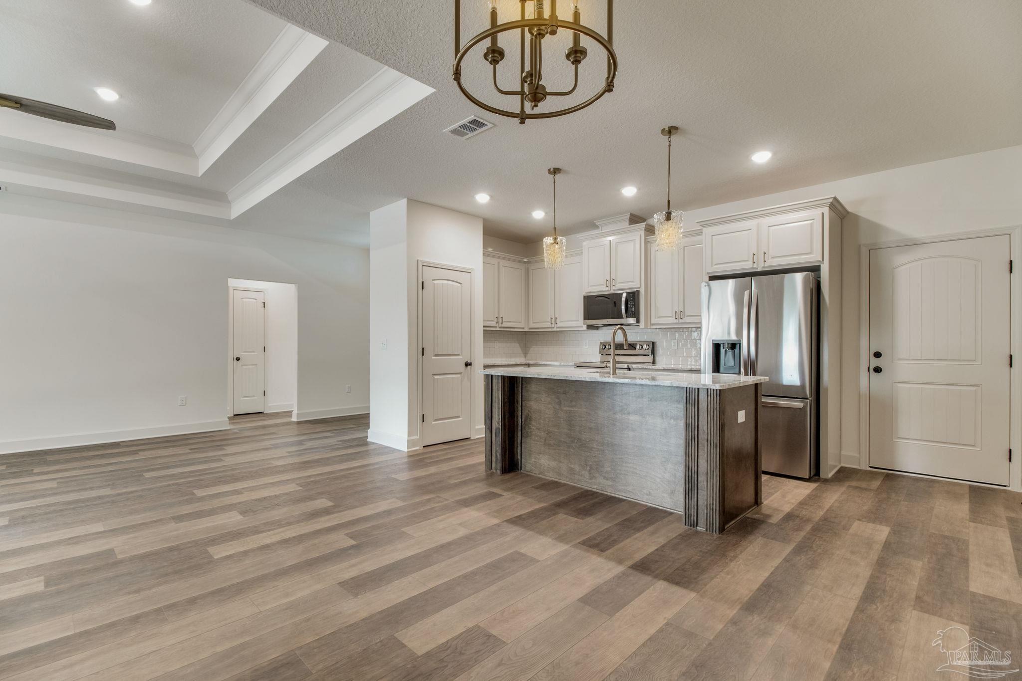 4310 Watkins Street Pace, FL 32571 - Photo 26 of 58 a view of a kitchen with a sink stainless steel appliances cabinets and a counter top space