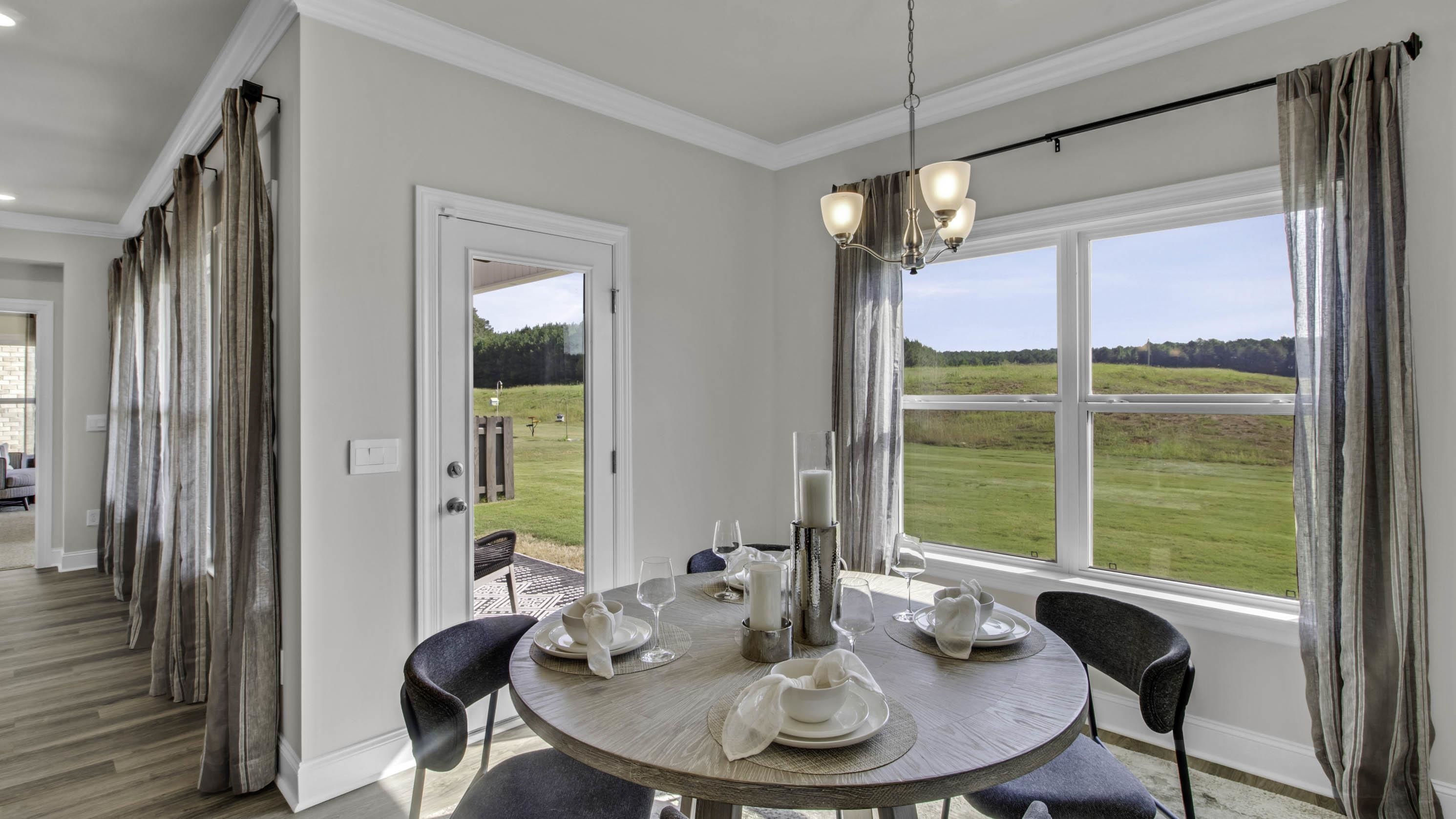 990 Mewborn Farm Road Oakland, TN 38060 - Photo 13 of 40 Dining area featuring ornamental molding, a chandelier, and light wood-style floors