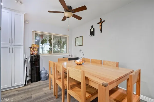 a view of a dining room with furniture and a chandelier fan