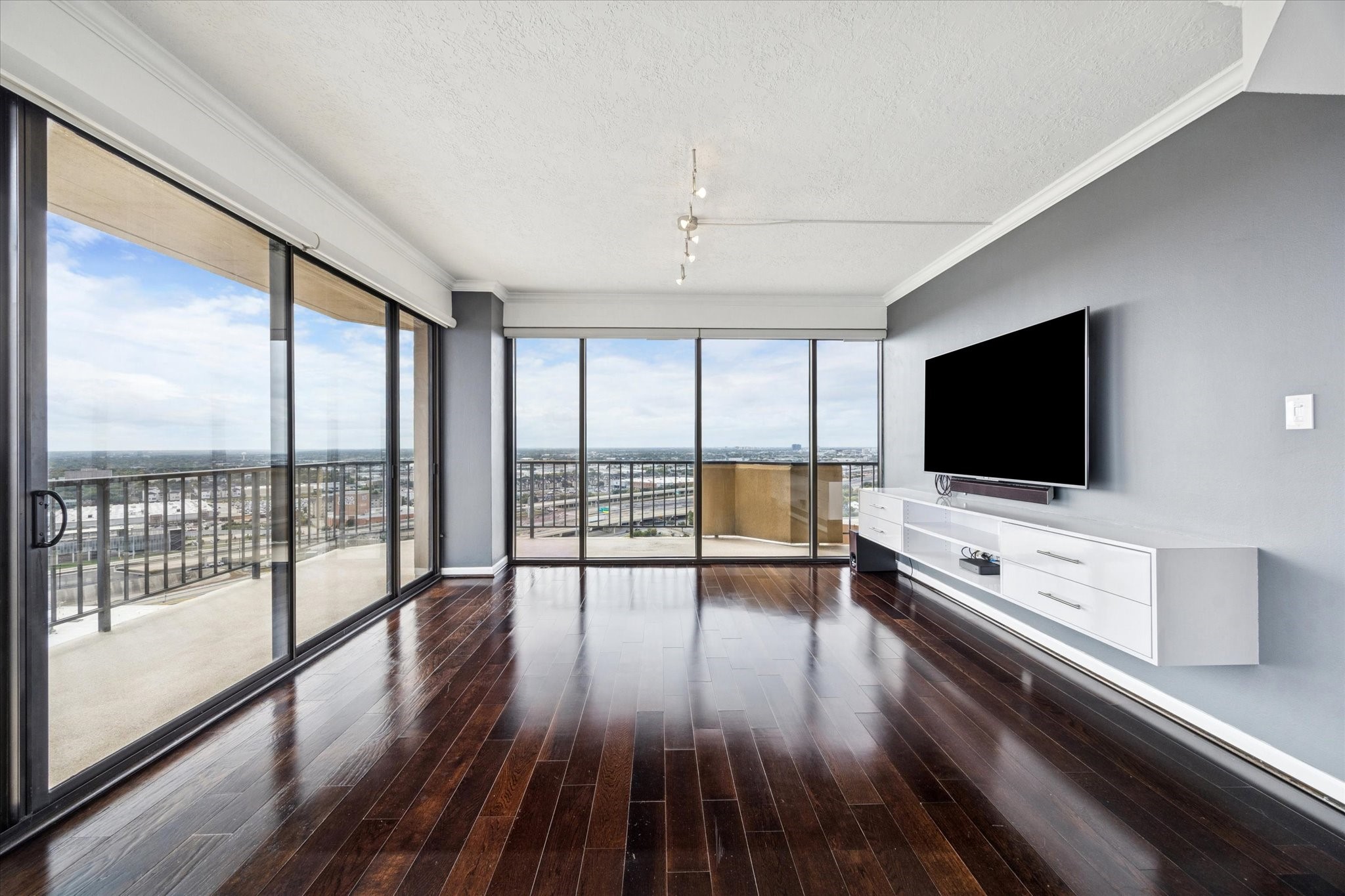 3350 McCue Road, Unit 2201 Houston, TX 77056 - Photo 2 of 27 a living room with flat screen tv and wooden floor