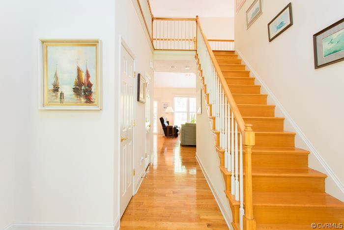 13713 Sandy Oak Road Chester, VA 23831 - Photo 3 of 24 a view of a hallway with wooden floor and windows