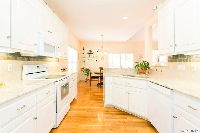 13713 Sandy Oak Road Chester, VA 23831 - Photo 8 of 24 a large white kitchen with cabinets
