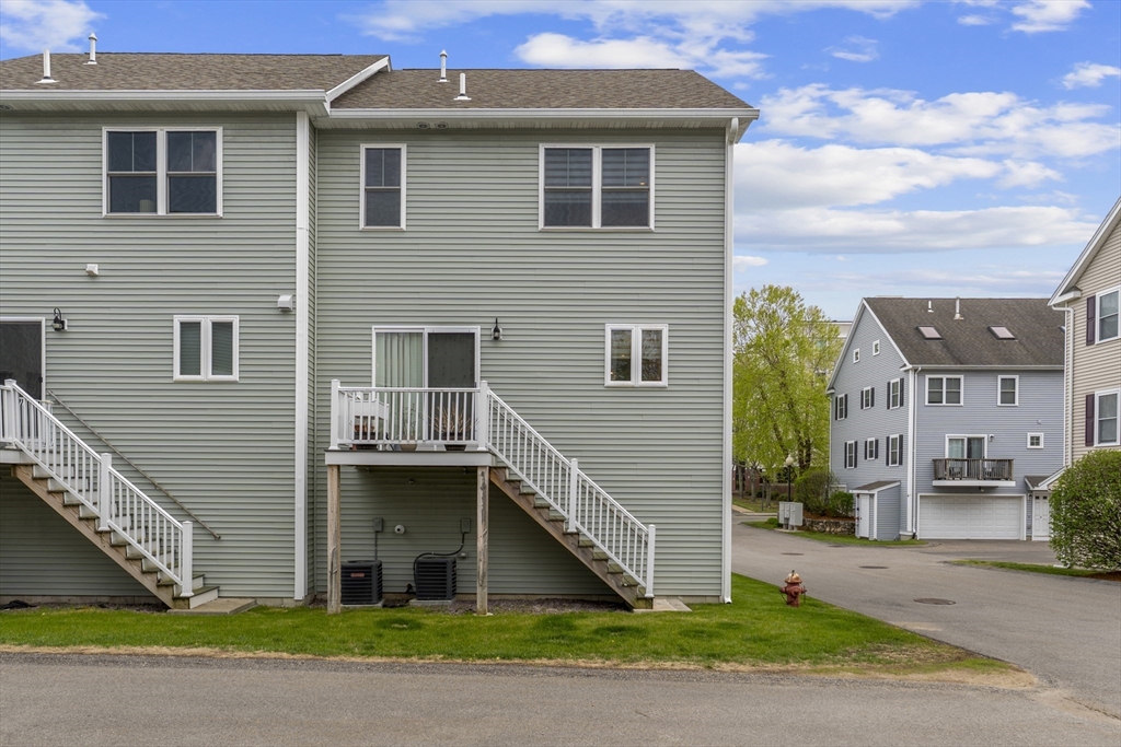 50 Des Moines Road, Unit H1 Quincy, MA 02169 - Photo 27 of 40 a front view of a house with a yard