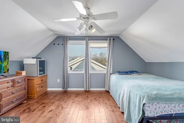 a bedroom with a bed dresser and a window