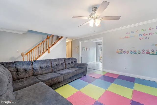a living room with furniture and a dining table