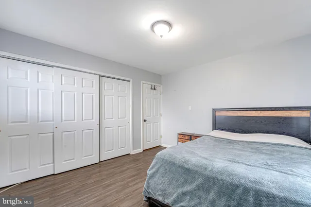 a bedroom with a bed and a night stand