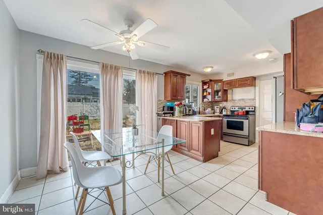 a living room with stainless steel appliances kitchen island granite countertop furniture and a kitchen view