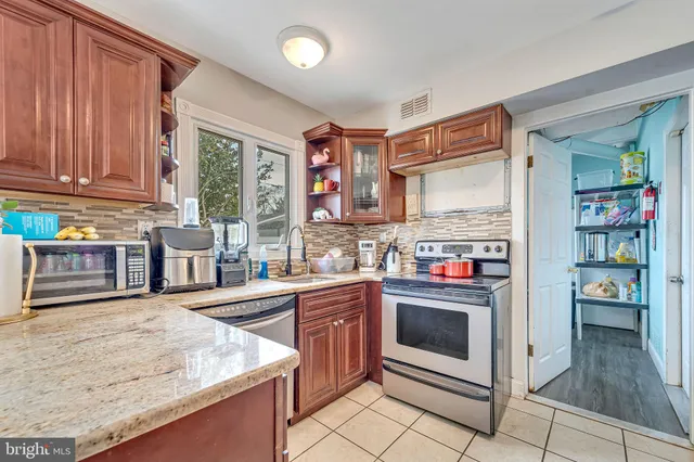 a kitchen with stainless steel appliances granite countertop a stove and a sink