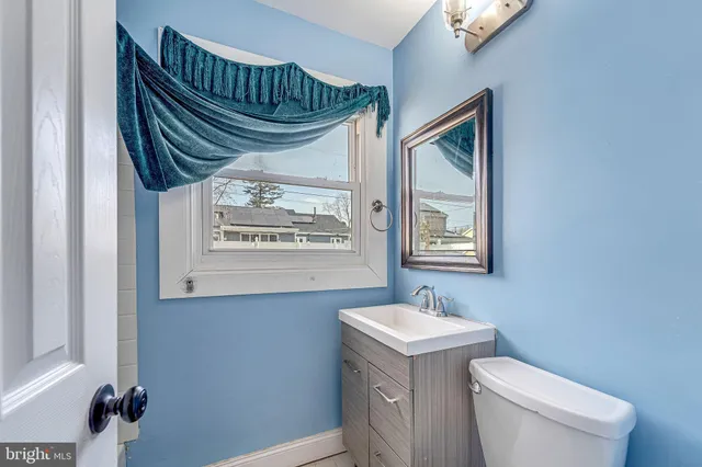 a bathroom with a sink a mirror and a toilet