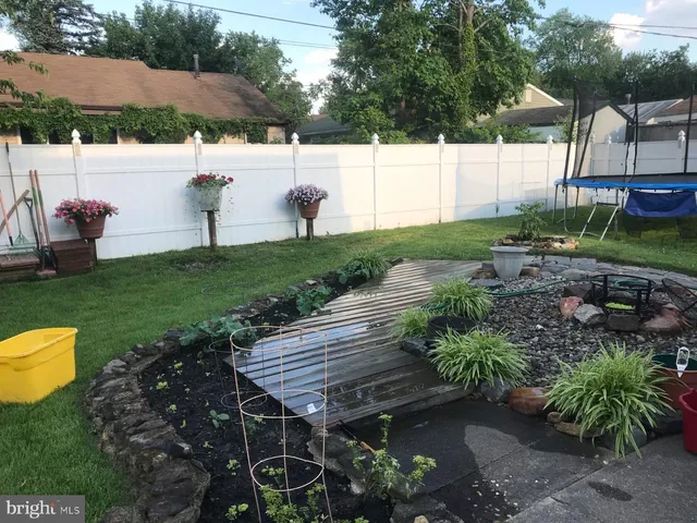 a view of a backyard with sitting area
