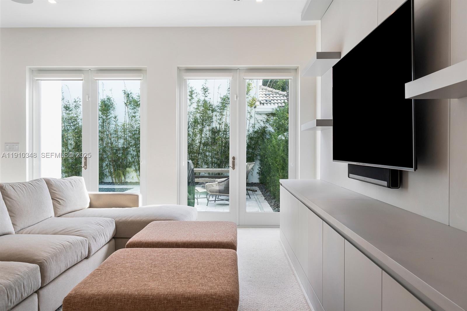 19941 Northeast 36th Place Aventura, FL 33180 - Photo 12 of 39 a living room with furniture and a flat screen tv