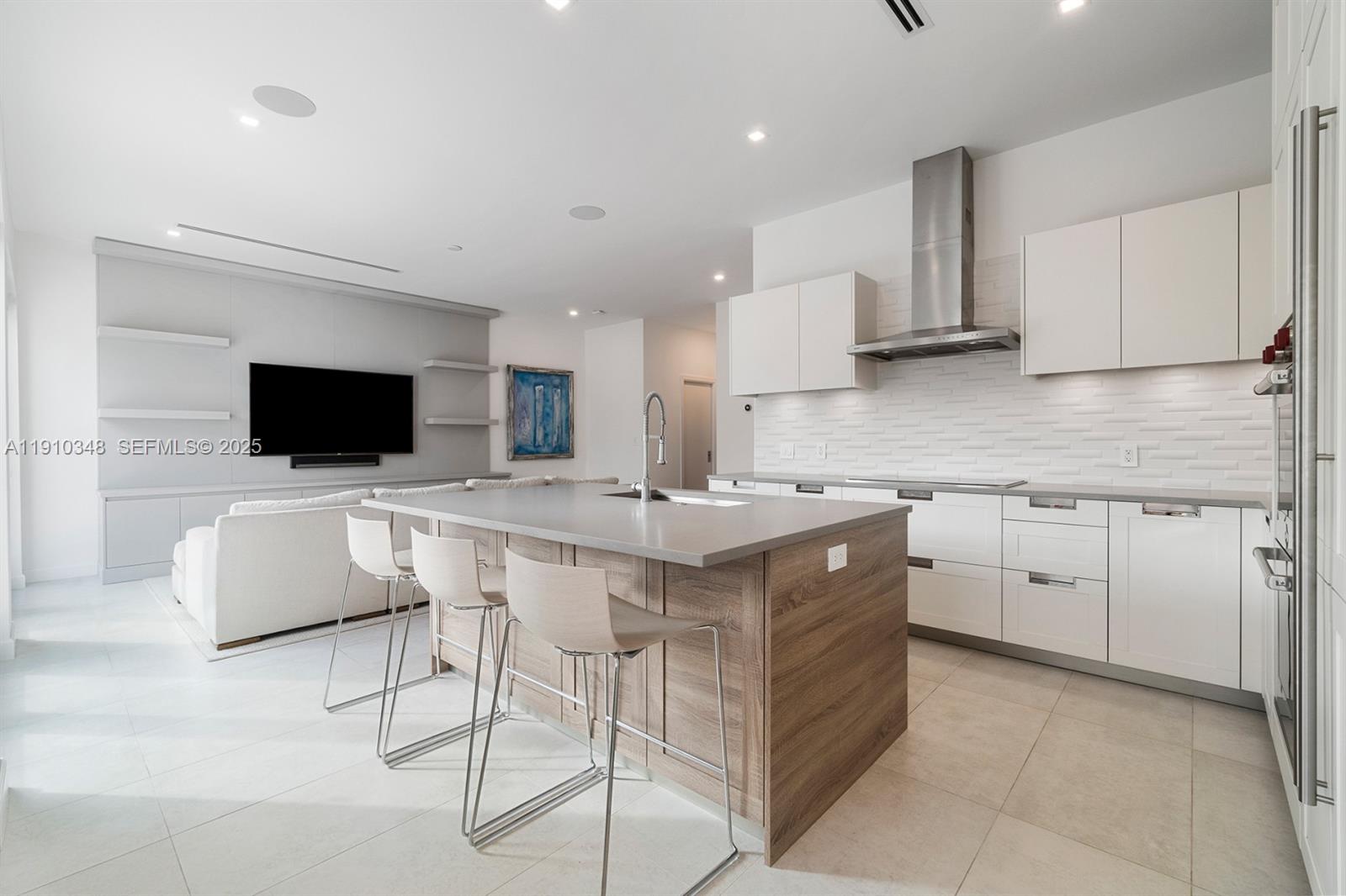 19941 Northeast 36th Place Aventura, FL 33180 - Photo 15 of 39 a kitchen with stainless steel appliances a stove top oven a sink a microwave a refrigerator and white cabinets