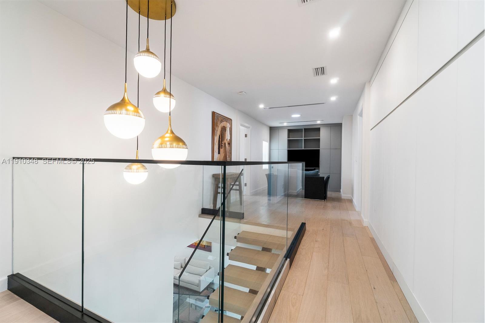 19941 Northeast 36th Place Aventura, FL 33180 - Photo 21 of 39 a view of a kitchen with wooden floor and chair