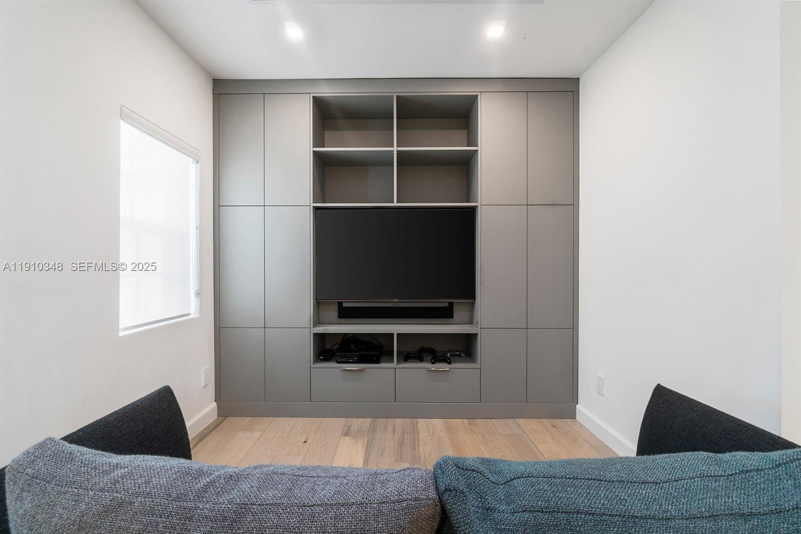 19941 Northeast 36th Place Aventura, FL 33180 - Photo 22 of 39 a living room with a couch and a flat screen tv