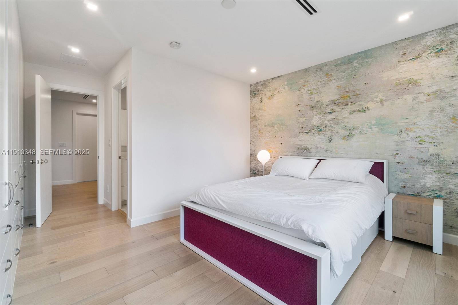 19941 Northeast 36th Place Aventura, FL 33180 - Photo 23 of 39 a bedroom with a bed and a view of bathroom