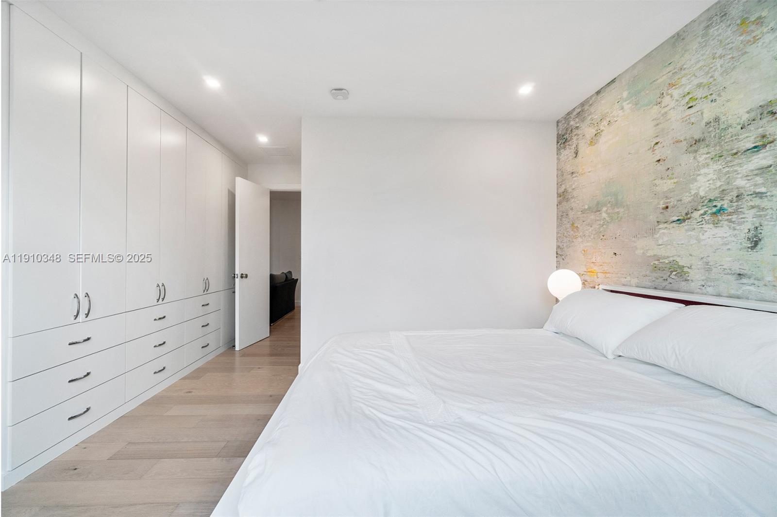 19941 Northeast 36th Place Aventura, FL 33180 - Photo 25 of 39 a large white bedroom with a large bed and white walls