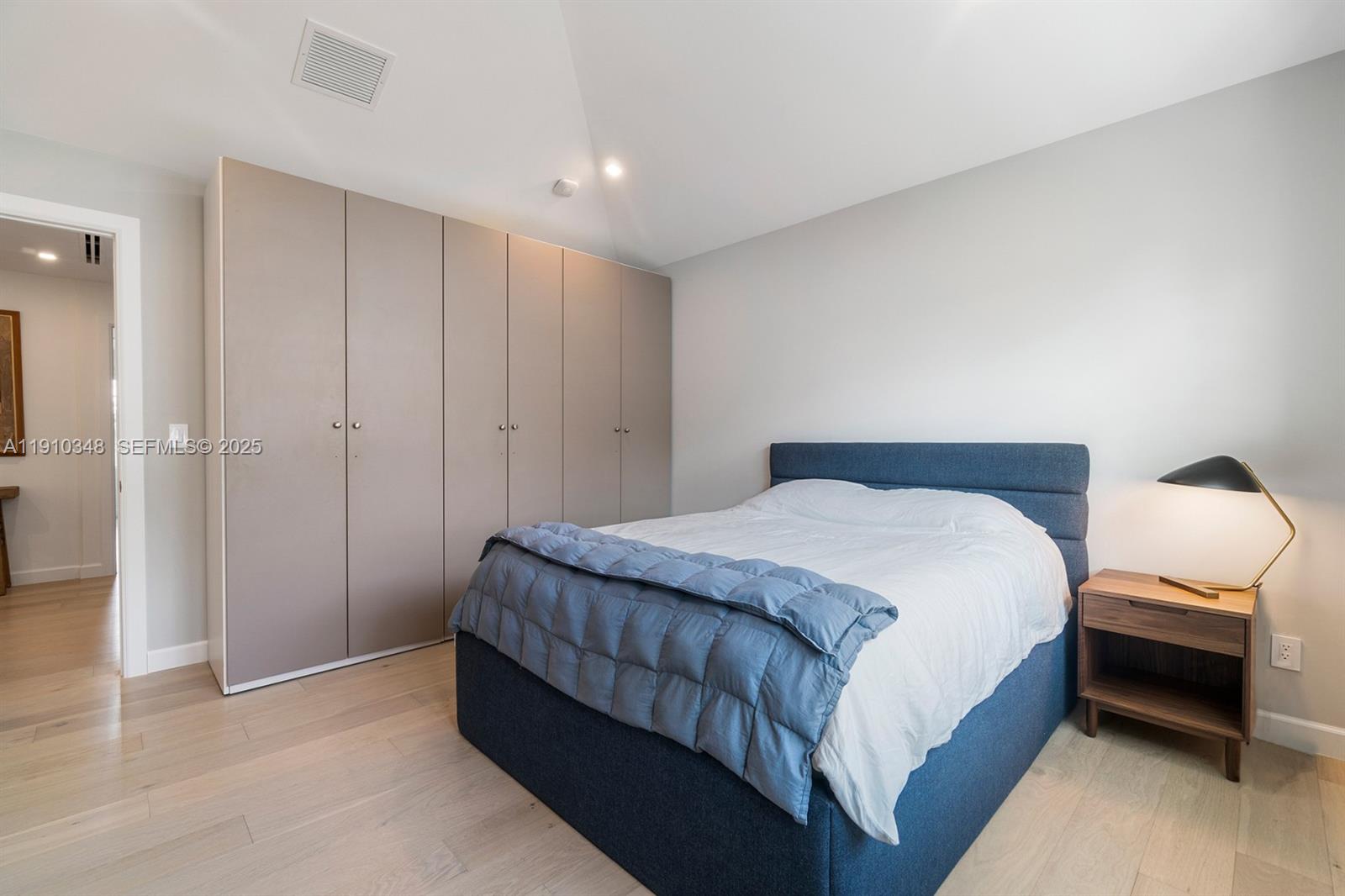 19941 Northeast 36th Place Aventura, FL 33180 - Photo 28 of 39 a bedroom with a bed and a night stand