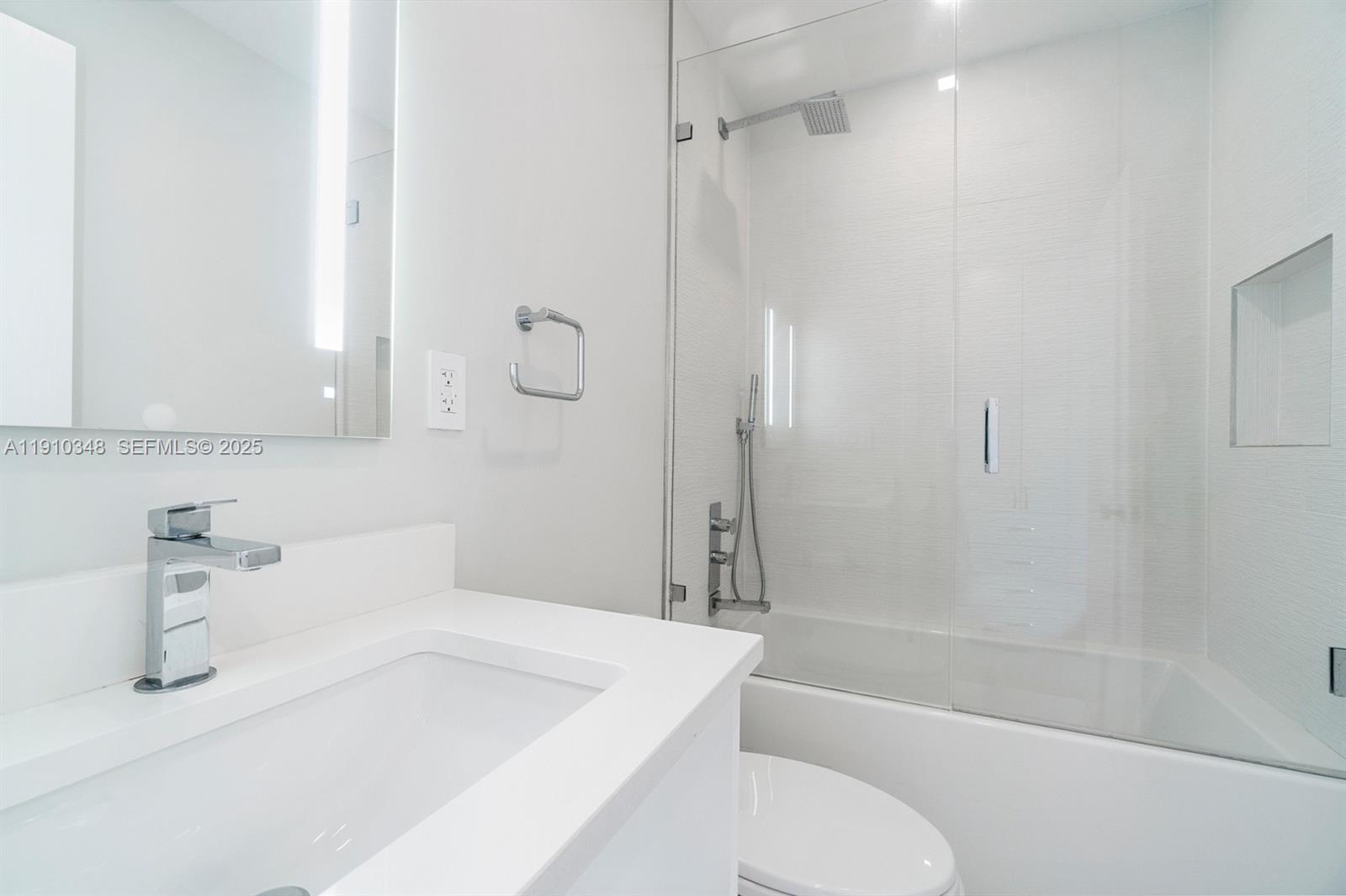 19941 Northeast 36th Place Aventura, FL 33180 - Photo 29 of 39 a bathroom with a sink a toilet and shower