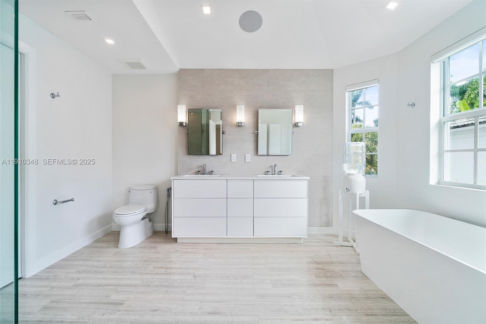 19941 Northeast 36th Place Aventura, FL 33180 - Photo 32 of 39 a bathroom with a sink a toilet and bathtub