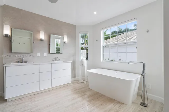 a bathroom with a bathtub and a sink