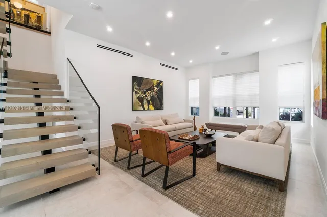 a living room with furniture and stairs