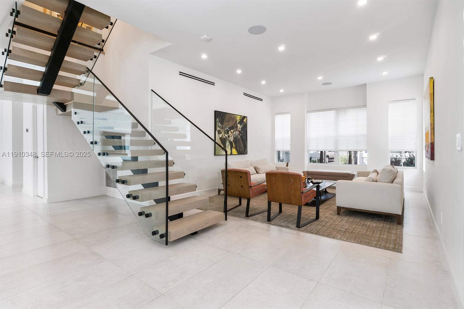 19941 Northeast 36th Place Aventura, FL 33180 - Photo 5 of 39 a living room with furniture and stairs