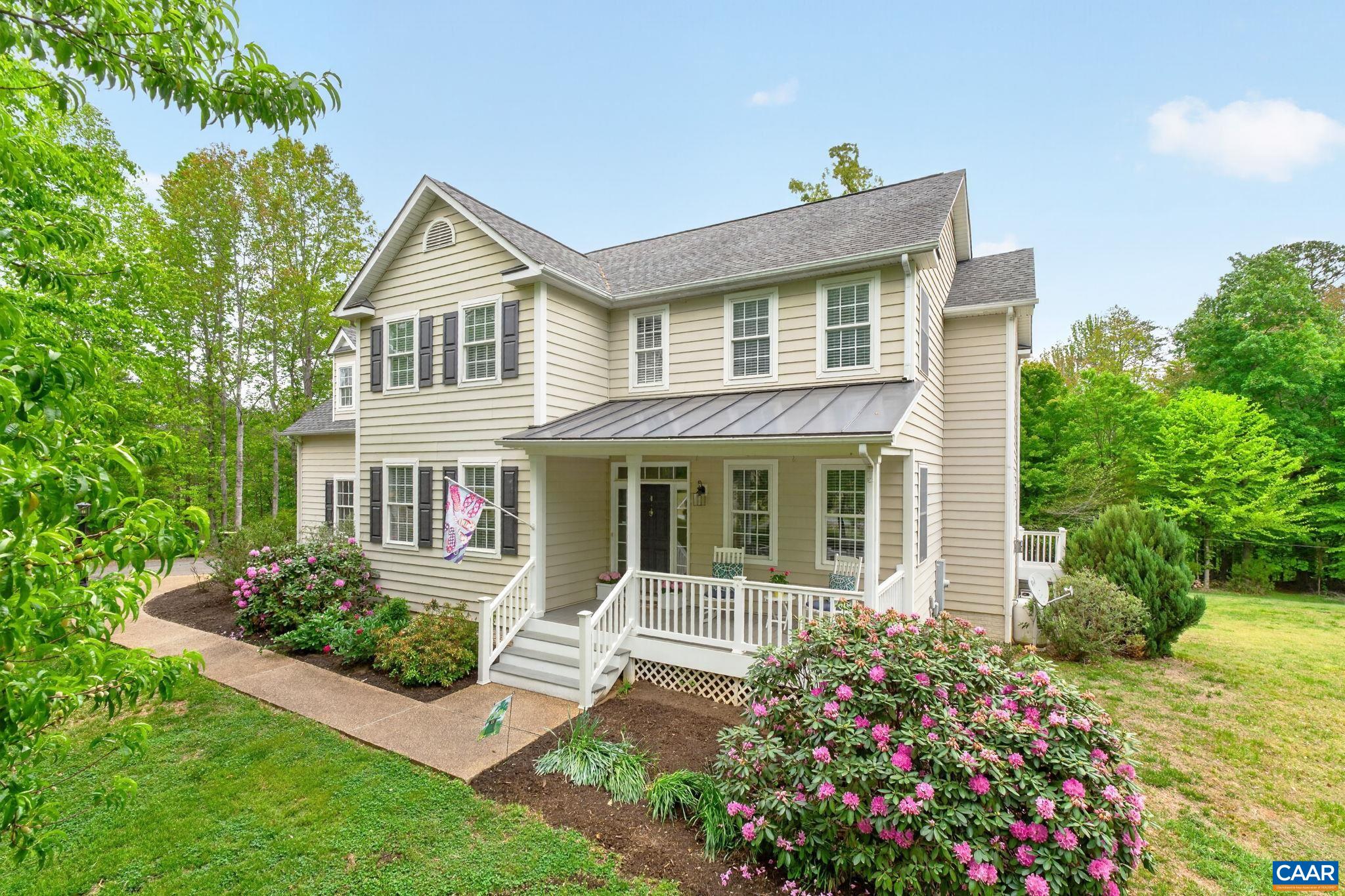 511 Taylor Ridge Way Palmyra, VA 22963 - Photo 2 of 57 a front view of a house with a garden
