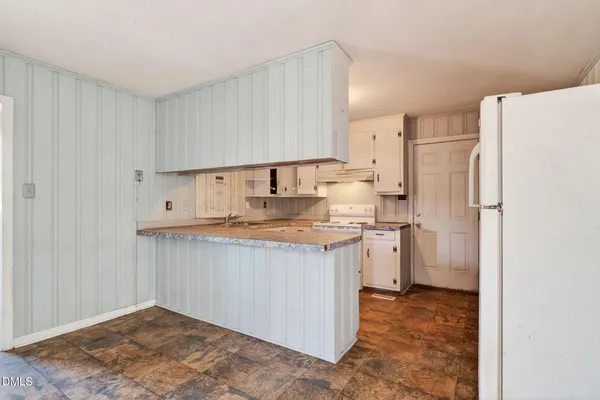 a kitchen with a sink a refrigerator and a stove