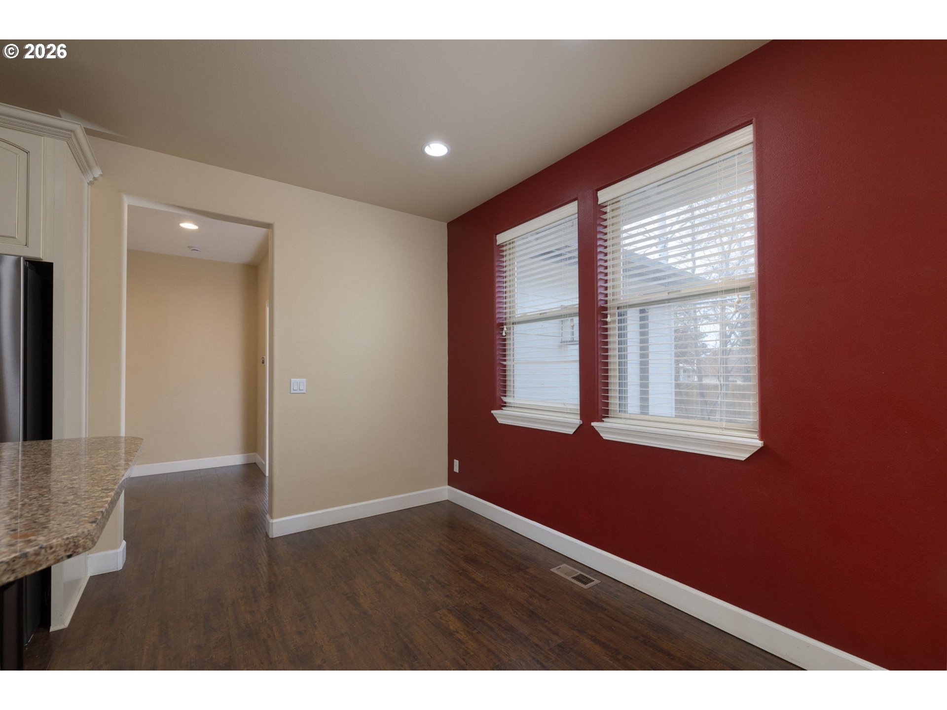 20246 Gaines Court Bend, OR 97702 - Photo 13 of 37 a view of an empty room with wooden floor and a window