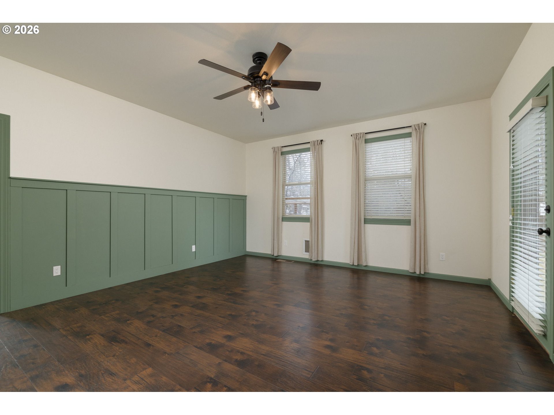 20246 Gaines Court Bend, OR 97702 - Photo 15 of 37 a view of an empty room with a window and wooden floor