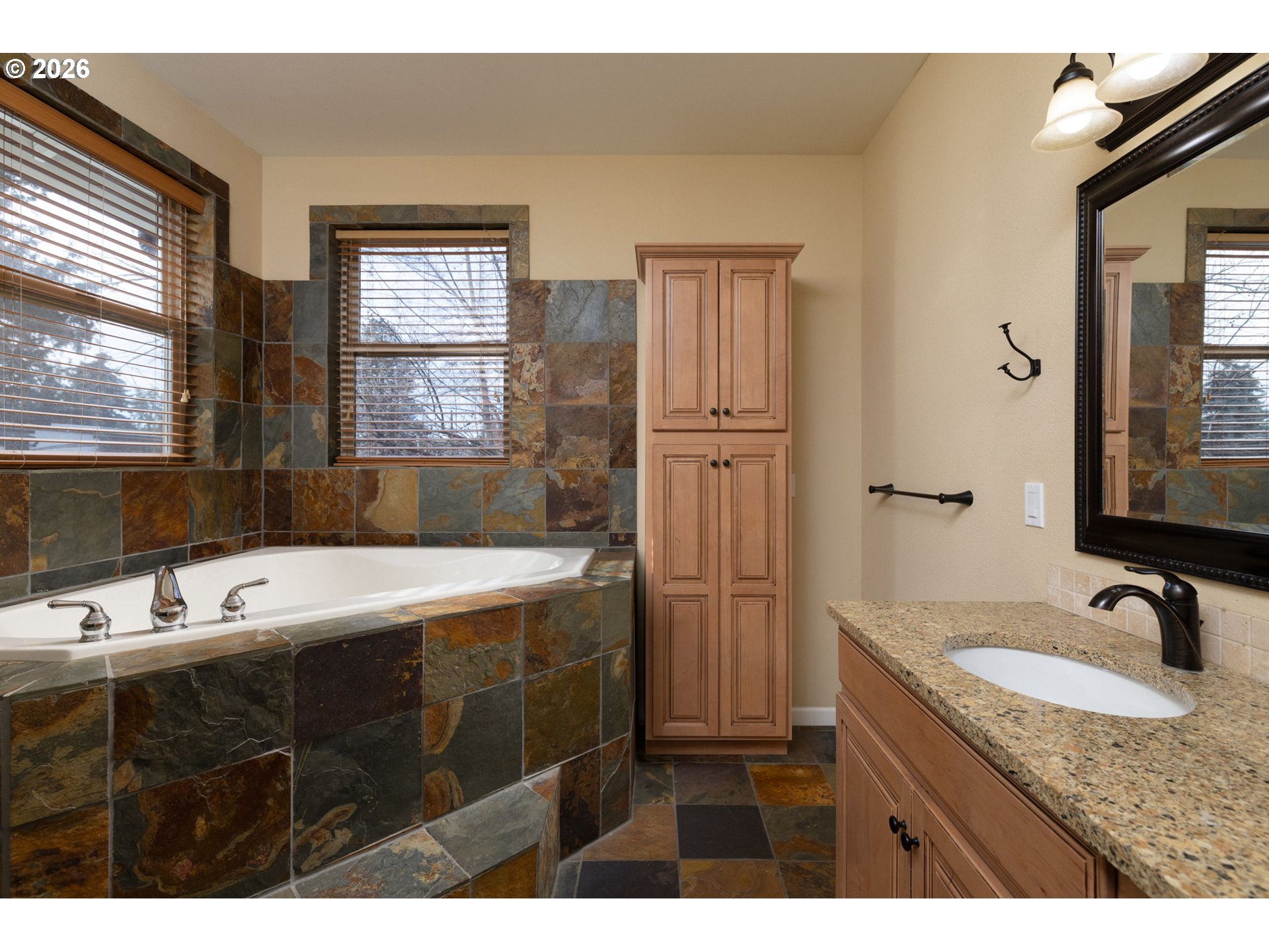 20246 Gaines Court Bend, OR 97702 - Photo 16 of 37 a bathroom with a granite countertop sink mirror and double