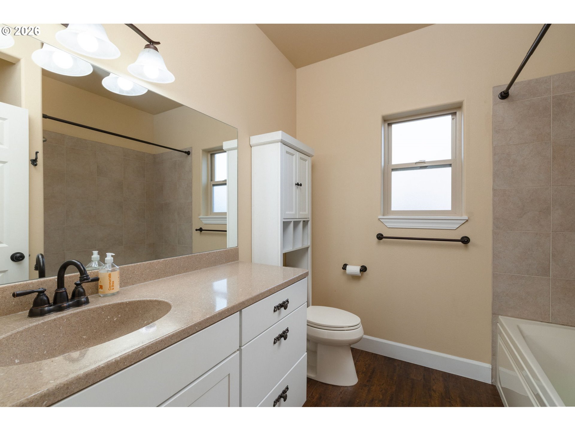 20246 Gaines Court Bend, OR 97702 - Photo 21 of 37 a bathroom with a double vanity sink a toilet and a mirror