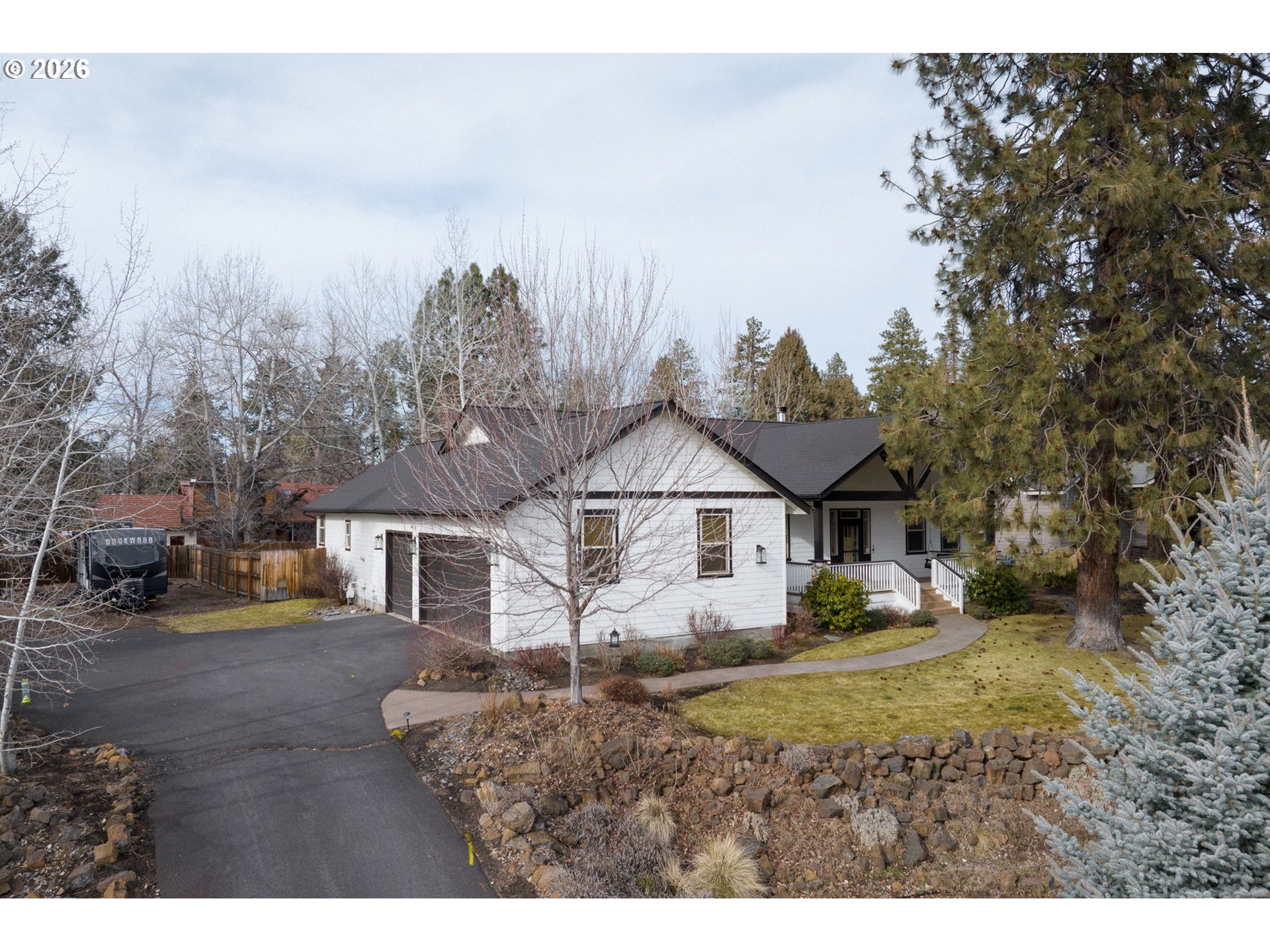 20246 Gaines Court Bend, OR 97702 - Photo 31 of 37 a view of a large house with a big yard and large tree