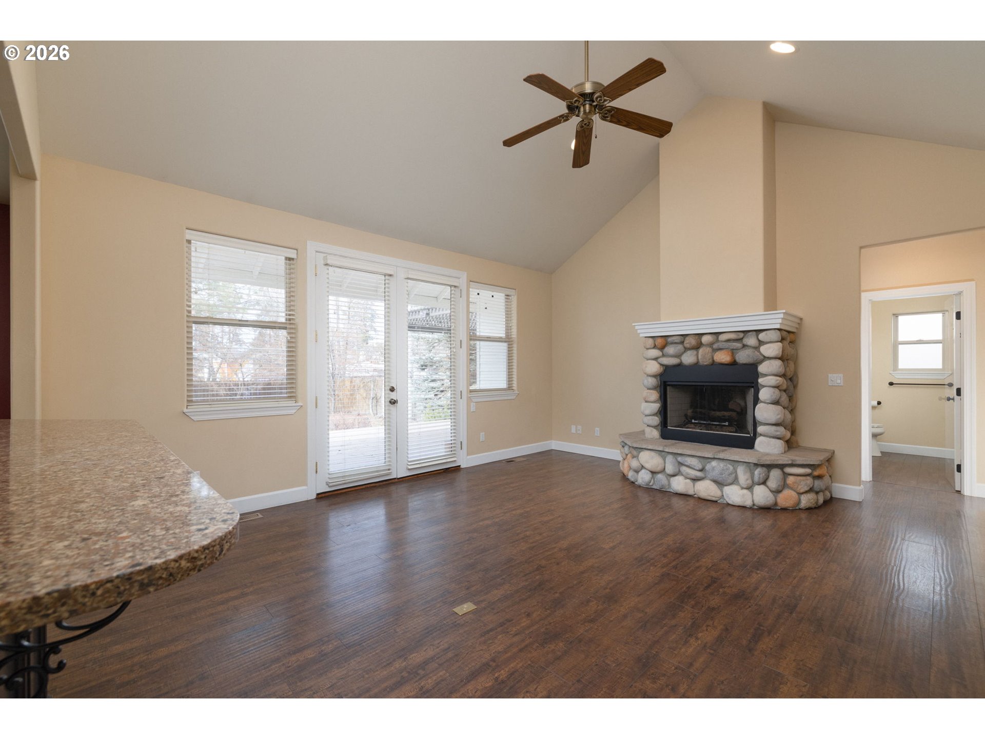 20246 Gaines Court Bend, OR 97702 - Photo 6 of 37 a view of empty room with fireplace and wooden floor