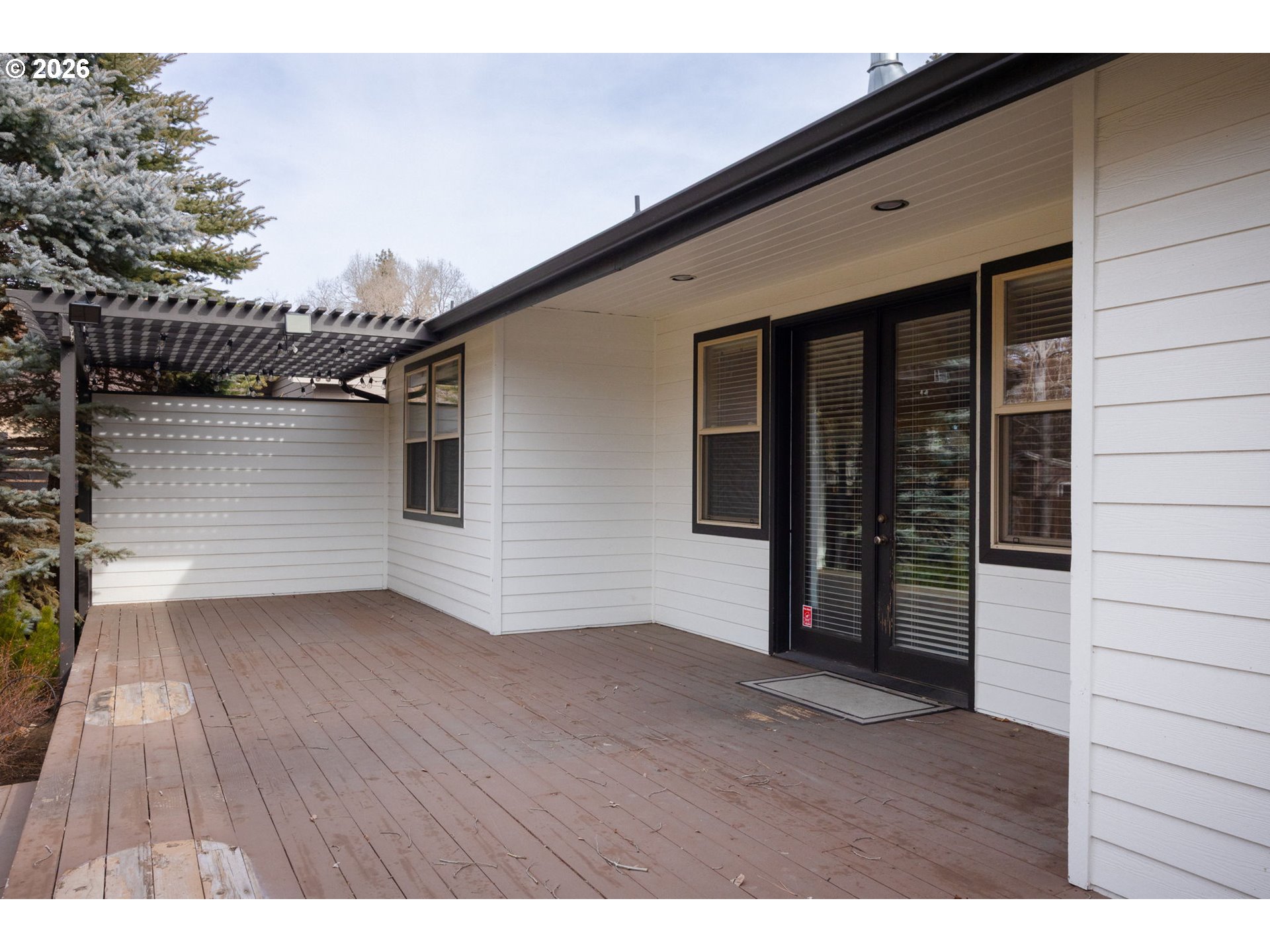 20246 Gaines Court Bend, OR 97702 - Photo 9 of 37 a view of an empty room with wooden floor and a window