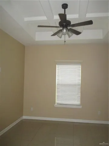 a view of room with a ceiling fan and window