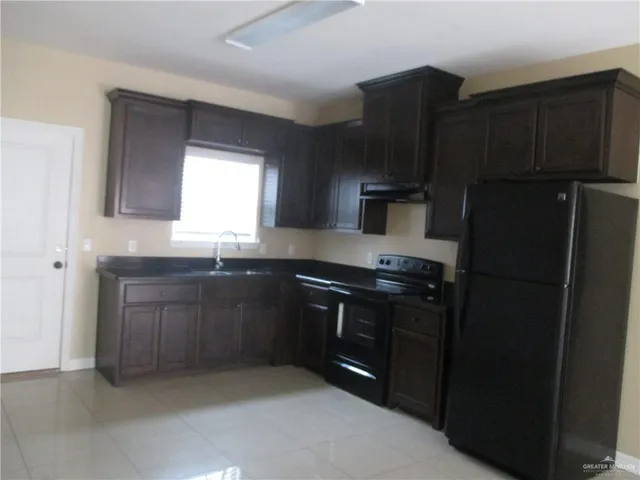 a kitchen with a refrigerator stove and sink