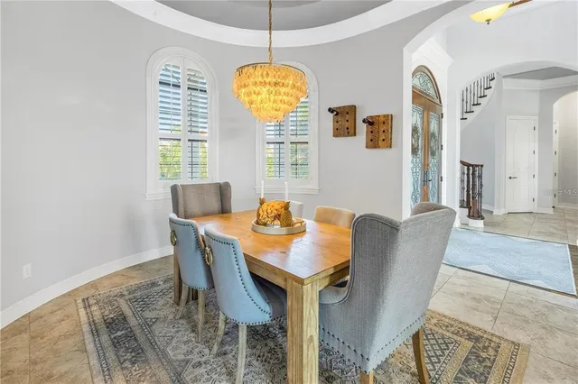 a view of a dining room with furniture and windows