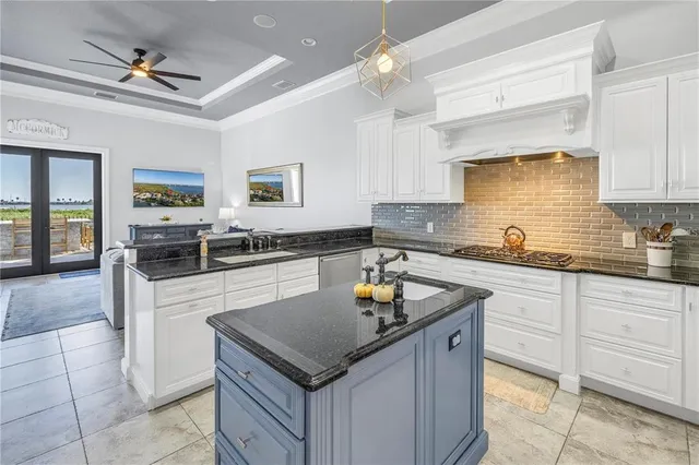 a kitchen with white cabinets and appliances