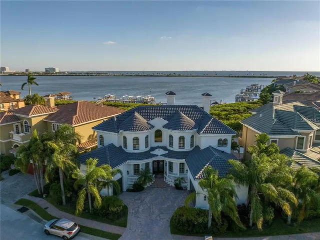 an aerial view of a house with a garden and lake view