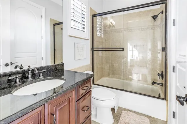 a spacious bedroom with a bed and a large window with wooden floor