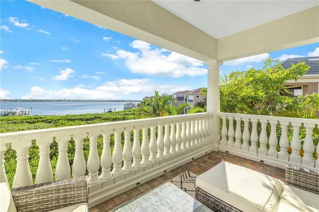 a hallway with painting on the wall and a window