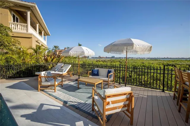 a swimming pool with outdoor seating and a tub