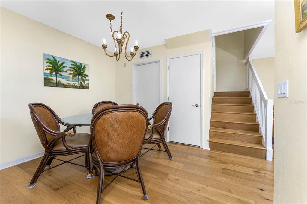 3021 Matecumbe Key Road, Unit 4 Punta Gorda, FL 33955 - Photo 11 of 42 a view of a hallway with wooden floor and a chandelier