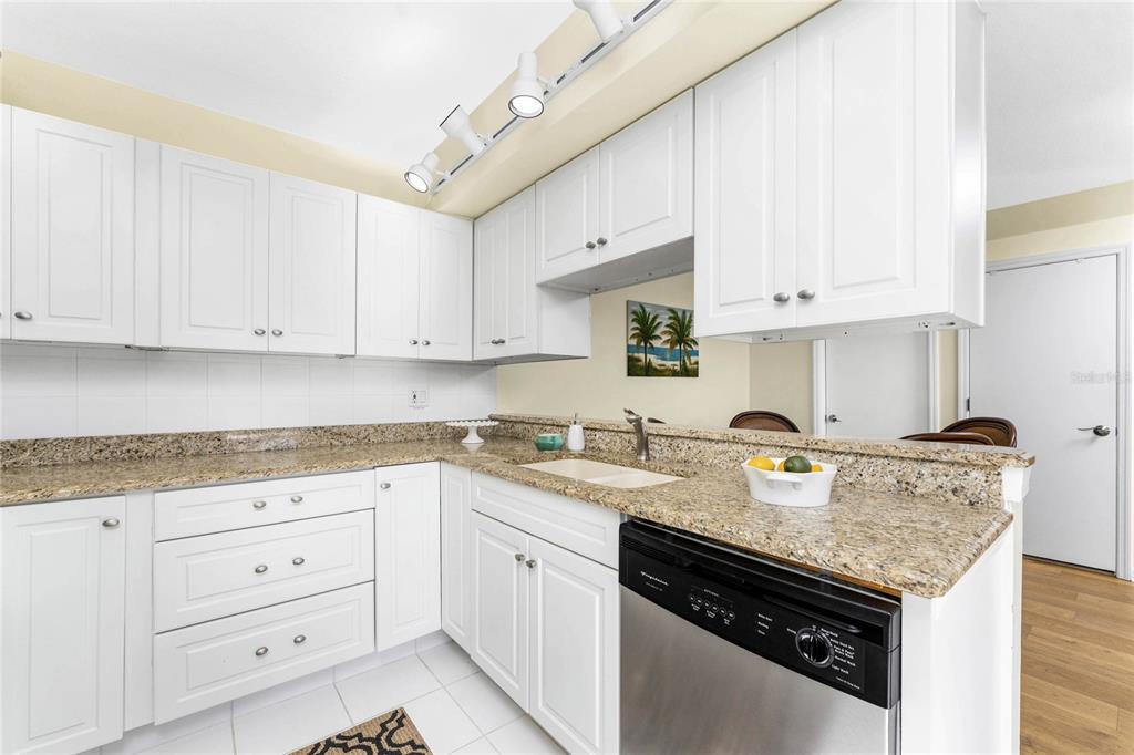 3021 Matecumbe Key Road, Unit 4 Punta Gorda, FL 33955 - Photo 17 of 42 a kitchen with granite countertop cabinets stainless steel appliances and a sink
