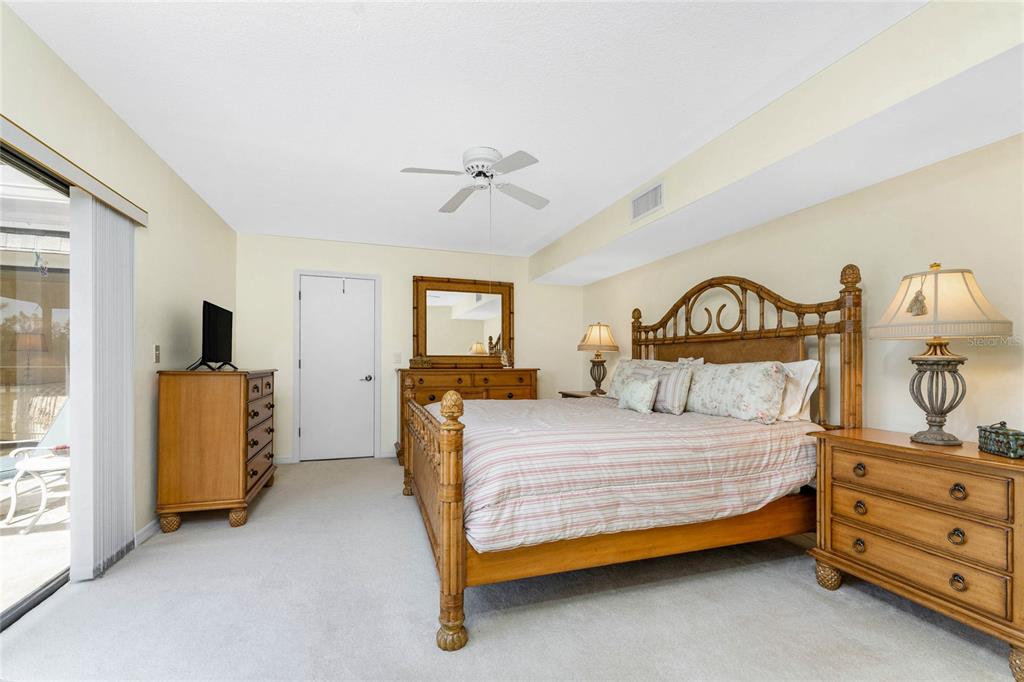 3021 Matecumbe Key Road, Unit 4 Punta Gorda, FL 33955 - Photo 21 of 42 a bedroom with a bed and a tv on the dresser